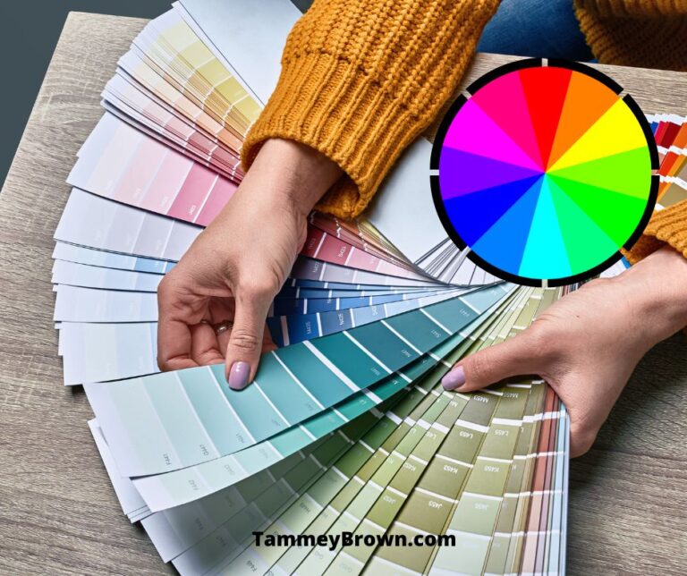Example of a color wheel and a person holding paint swatches over the color wheel for the blog post